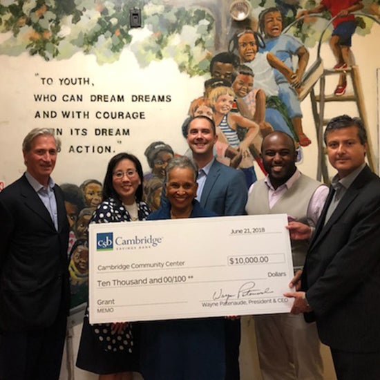 Representatives from CSB and the Cambridge Community Center posing with large check