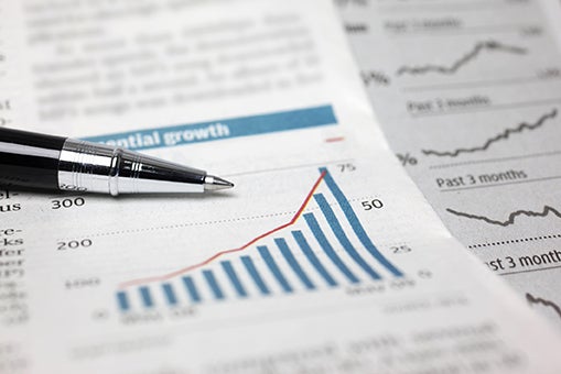 A pen on top of a paper that shows a financial graph