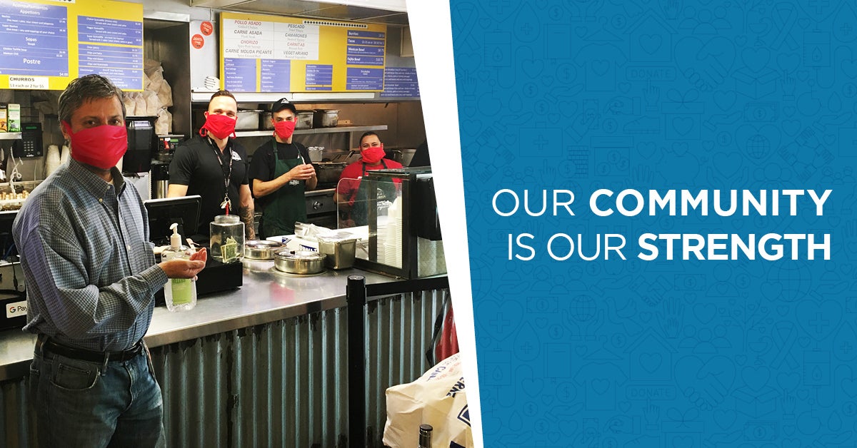 CSB employee getting take out at a restaurant, with 3 restaurant employees all wearing masks. Text to the side of image saying Our community is our strength.
