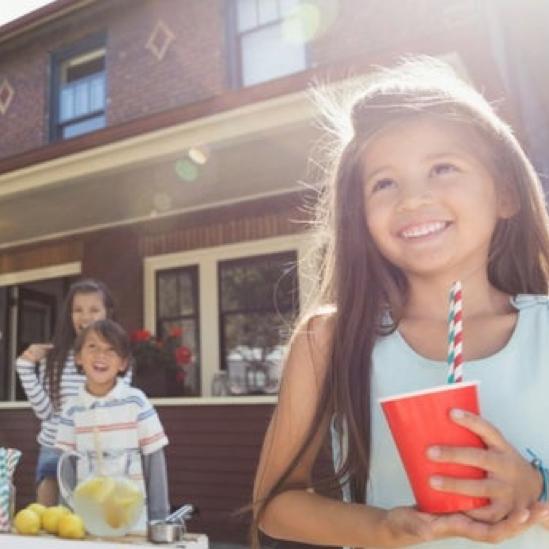 Happy children at a lemonade stand