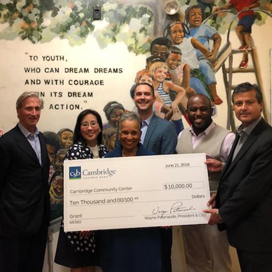 Representatives from CSB and the Cambridge Community Center posing with large check