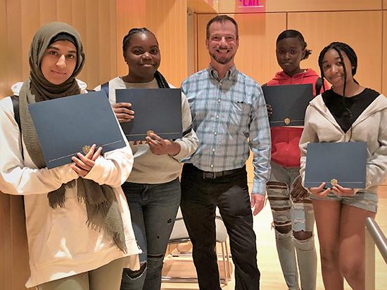 CSB employee with 4 participants in the Mayor’s Summer Youth Employment Program holding up certificates