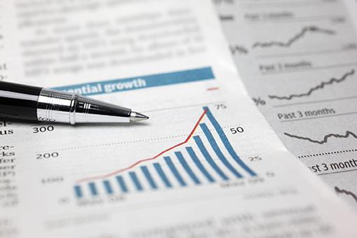 A pen on top of a paper that shows a financial graph