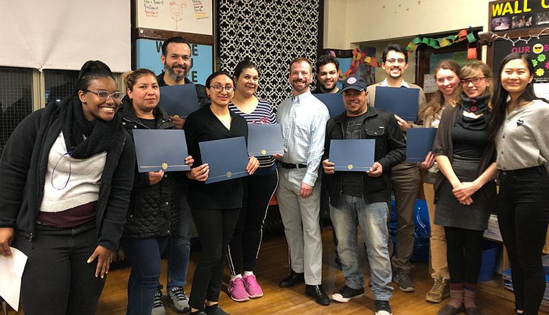 CSB employee and students posing in a classroom at a credit workshop