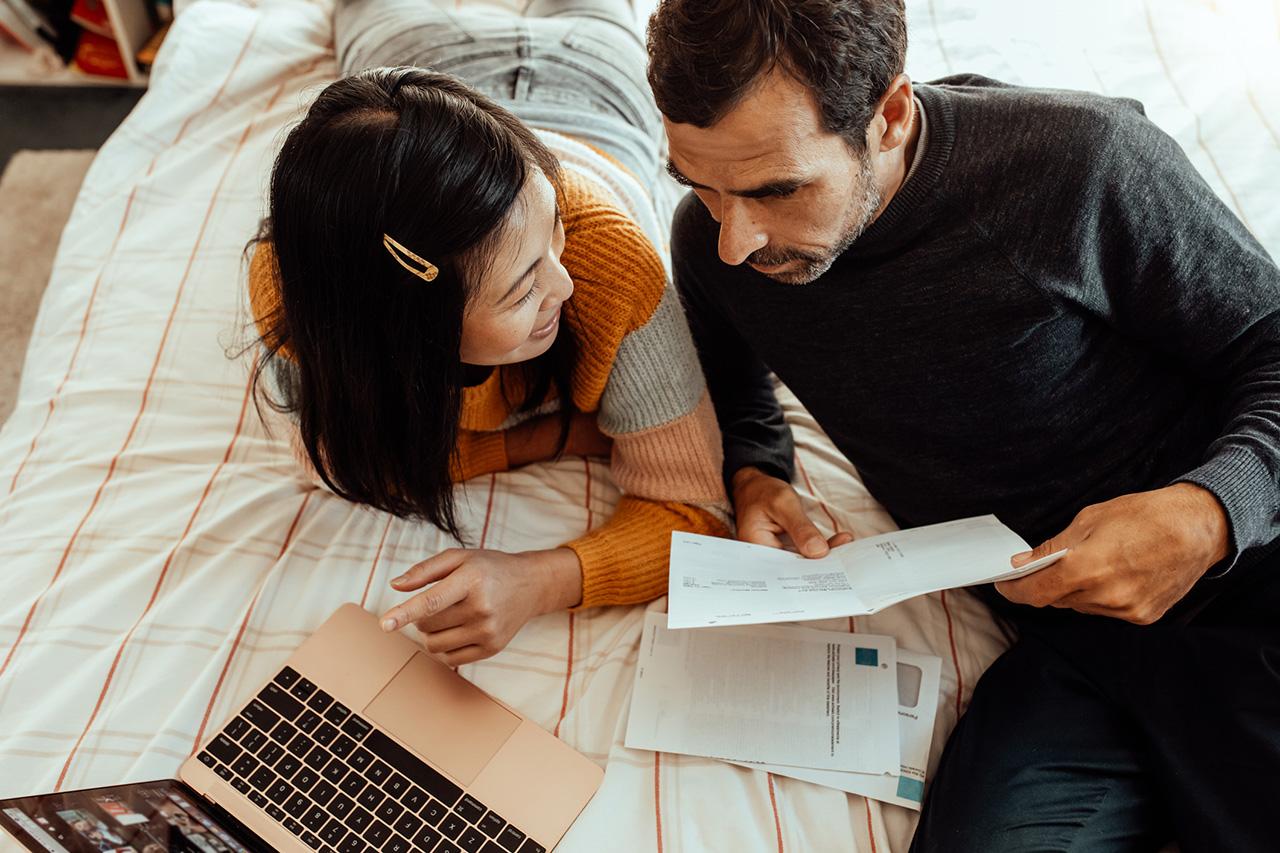 Couple with budgets and laptop