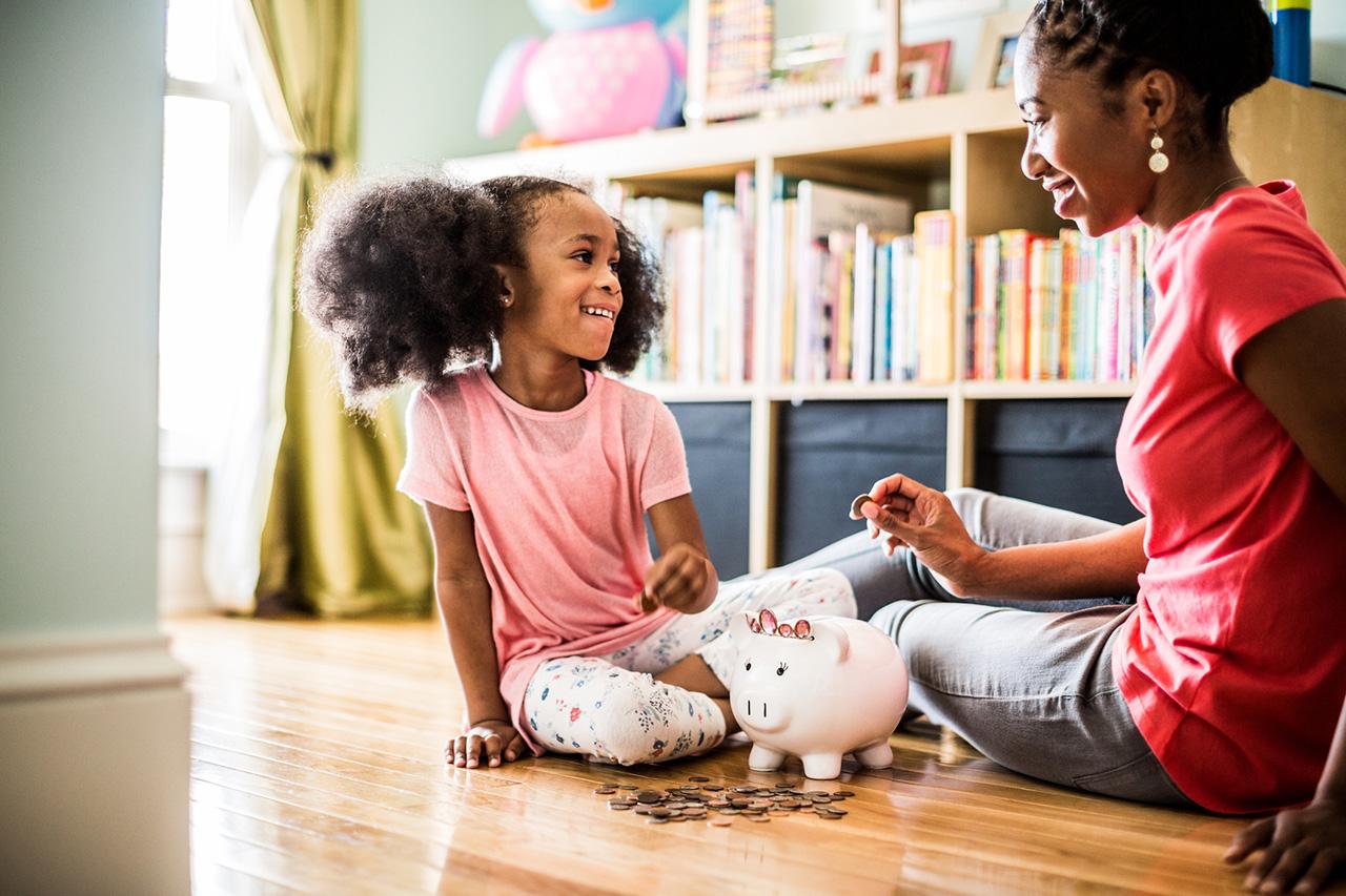 Mother and daughter with piggy bank