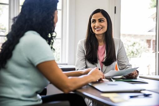 A loan officer meeting with her client