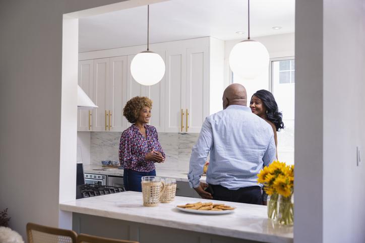 A real estate agent and couple at an open house